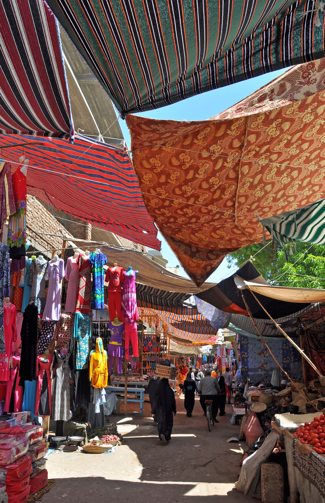 A lantern-lit alley in the Luxor souq at evening